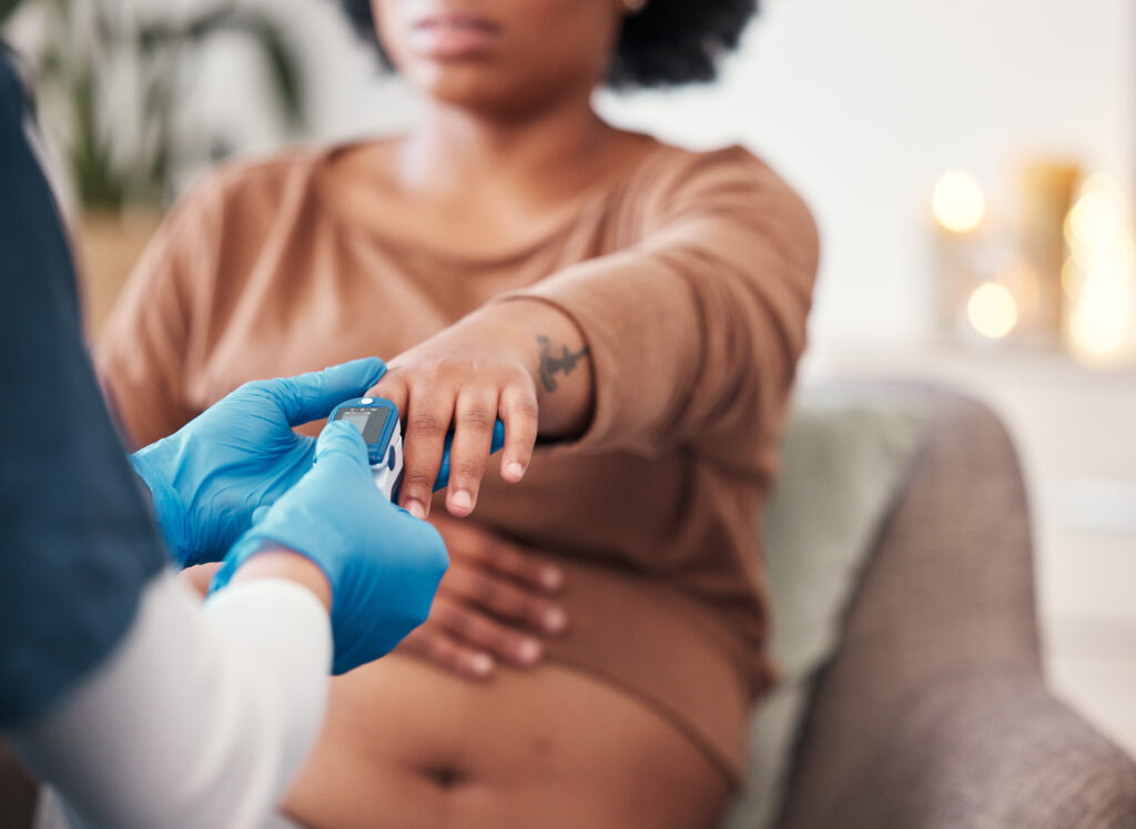 A woman getting her pulse taken for a high risk pregnancy support situation in Lorain County Ohio