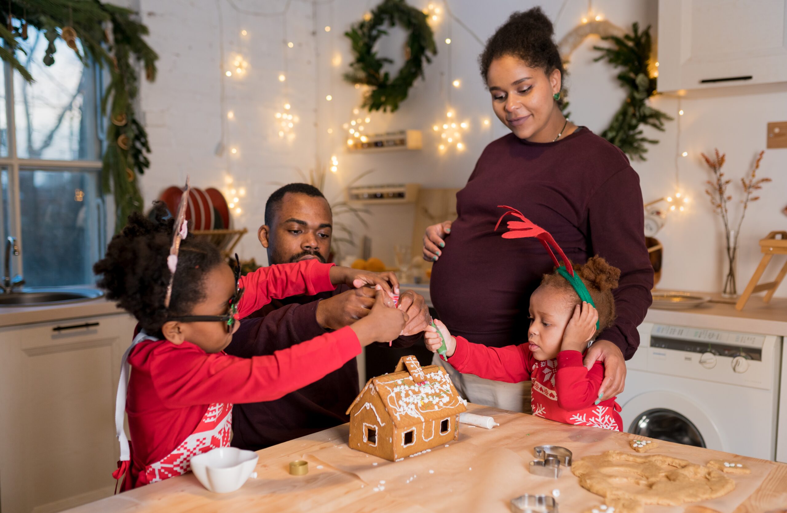 African-American family decorating a gingerbread house in Elyria, OH.